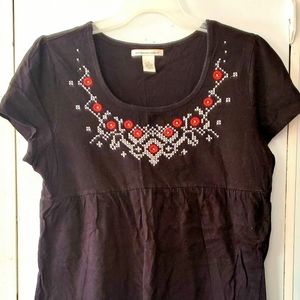 Black shirt with red flowers with white designs around them